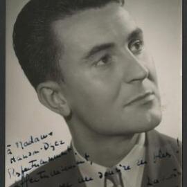 Promotional headshot of French harpsichordist Robert Veyron-Lacroix wearing a dark suit and tie