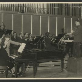 Swiss harpsichordist Isabelle Nef in a recording session with a small orchestra, conductor and page turner
