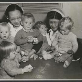 AIF Malaya Memorial Nursing Scholarship recipients with group of toddlers playing with blocks