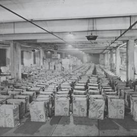 Boxes  in a warehouse with cloth covers with Red Cross emblem