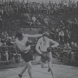 Unidentified prisoners of war camp: Boxing match watched on by large crowd of men