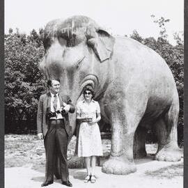 [Malcolm and Tamie Fraser in front of an elephant statue during a visit to China]