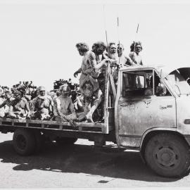 [A group of Aboriginal Australian men in ceremonial painting on the back of a truck]