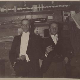 [Two men wearing three piece suits] 