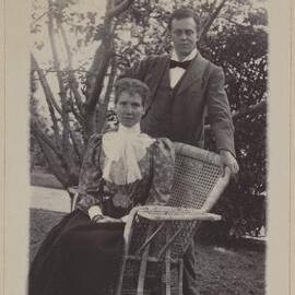 [Man and Mrs Blanch seated in cane chair] Harleston [garden]