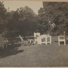 [Mabel Grimwade and Caesar the bulldog in garden]