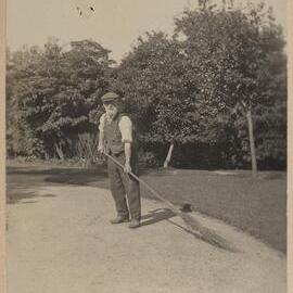 [Man with straw sweeper]