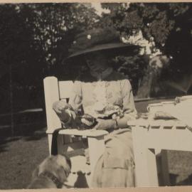 [Woman seated in garden]