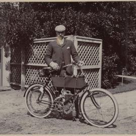 [Man posing with bicycle]