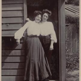 [Two women posing in doorway]