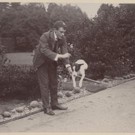 Harleston [man with dog jumping over stick]
