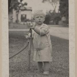 [Small boy playing with garden tap]