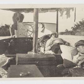 [Men laying down in boat, 'The Thistle']