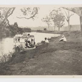 [Boat moored on river bank]