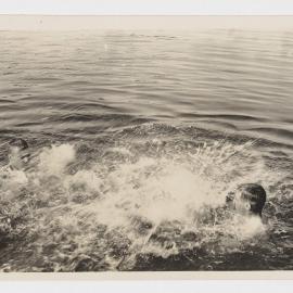 [Two men splashing in river]