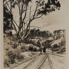 [Three men walking on railway tracks]