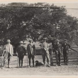 [Group photo of five men and one young man]
