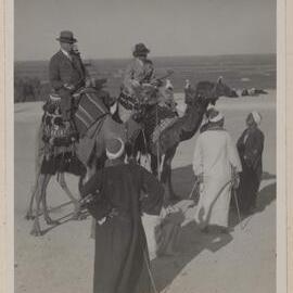 [Man and woman riding camels, Cairo, Egypt]