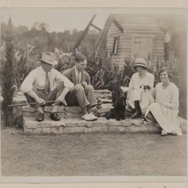 [Group seated on stone steps of lily pond] Westerfield Xmas 1930