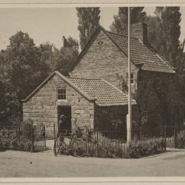 [External view of Cooks' Cottage, Fitzroy Gardens, Melbourne showing the iron entrance gate]