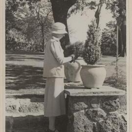 [Mabel tending potted plants, Miegunyah Garden]
