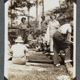 [Earnie Bond's homestead people sitting near fencing]