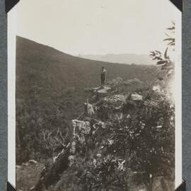 [Mountaineering Club Tasmania trip - man standing on cliff edge]